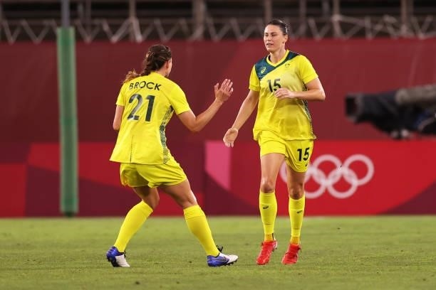 Emily Gielnik of Team Australia celebrates with teammate Laura Brock after scoring their side's third goal during the Women's Bronze Medal match...