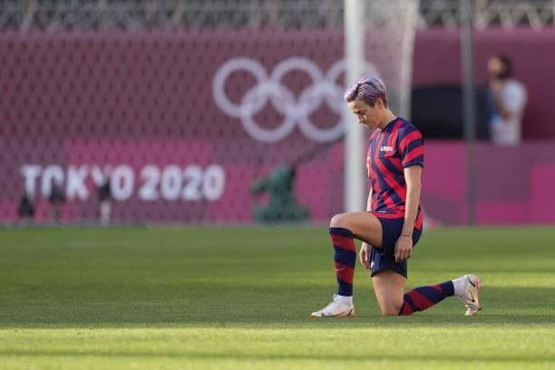 Megan Rapinoe of the United States takes a knee before a game between Australia and USWNT at Kashima Soccer Stadium on August 5, 2021 in Kashima,...