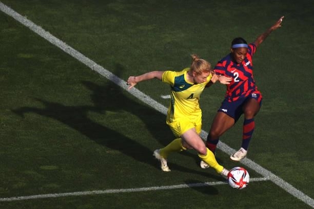 Crystal Dunn of Team United States is challenged by Clare Polkinghorne of Team Australia during the Women's Bronze Medal match between United States...