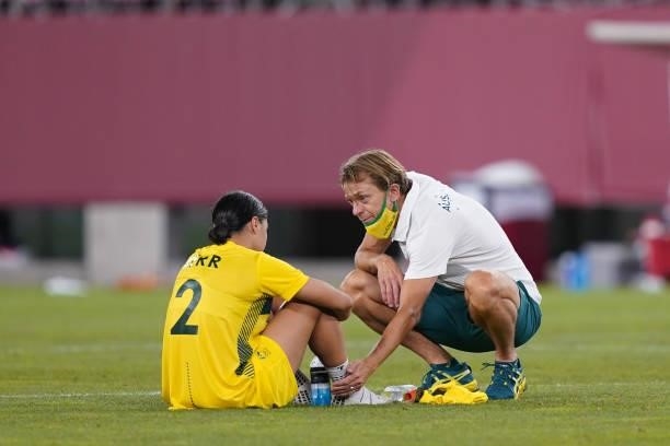 Australia head coach Tony Gustavsson talks with Sam Kerr after a game between Australia and USWNT at Kashima Soccer Stadium on August 5, 2021 in...
