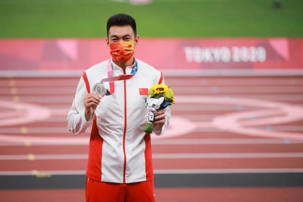 Silver medalist Zhu Yaming of Team China celebrates on the podium during the medal ceremony for the Men's triple jump on day thirteen of the Tokyo...