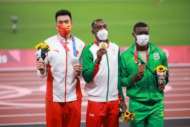 Silver medalist Zhu Yaming of Team China, gold medalist Pedro Pichardo of Team Portugal and bronze medalist Hugues Fabrice Zango of Team Burkina Faso...