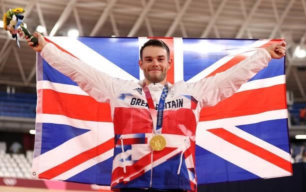 Gold medalist, Matthew Walls of Team Great Britain, poses while holding the flag of his country during the medal ceremony after the Men's Omnium...