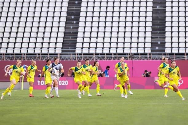 Players of Team Australia run onto the field during the Olympic football bronze medal match between United States and Australia at Kashima Stadium on...