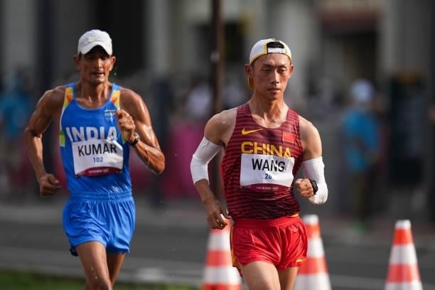 Wang Kaihua of Team China and Kumar Sandeep of Team India compete in the Men's 20km Race Walk Final on day thirteen of the Tokyo 2020 Olympic Games...
