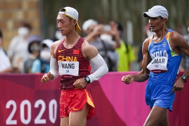 Wang Kaihua of Team China and Kumar Sandeep of Team India compete in the Men's 20km Race Walk Final on day thirteen of the Tokyo 2020 Olympic Games...