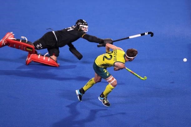 Flynn Andrew Ogilvie of Team Australia scores their team's second penalty in the penalty shootout past Vincent Vanasch of Team Belgium during the...