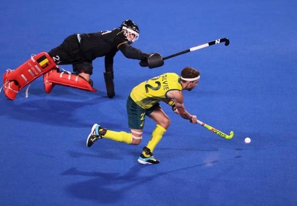 Flynn Andrew Ogilvie of Team Australia scores their team's second penalty in the penalty shootout past Vincent Vanasch of Team Belgium during the...