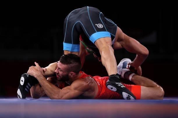 Thomas Patrick Gilman of Team United States competes against Reza Atrinagharchi of Team Iran during the Men's Freestyle 57kg Bronze Medal Match on...