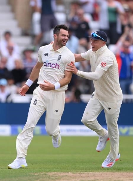 England bowler James Anderson celebrates with Sam Curran after taking the wicket of Virat Kohli first ball during day two of the First Test Match...