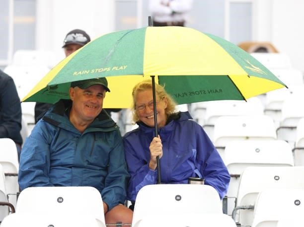 Spectators shelter from the rain during day two of the First LV= Insurance test match between England and India at Trent Bridge on August 05, 2021 in...
