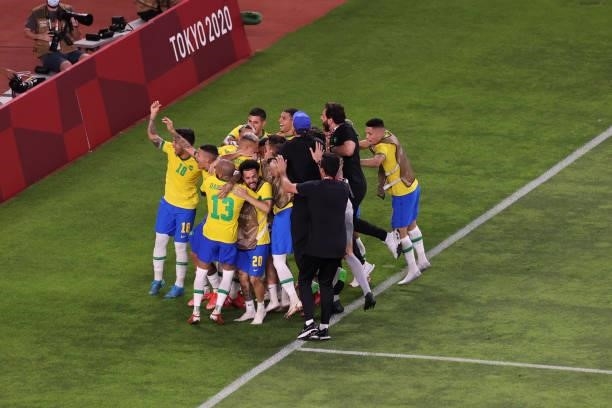 The team celebrates after Reinier of Team Brazil scores a penalty kick during the penalty shoot out in the Men's Football Semi-final match between...