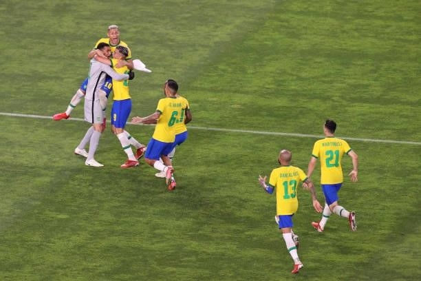 The team celebrates after Reinier of Team Brazil scores a penalty kick during the penalty shoot out in the Men's Football Semi-final match between...
