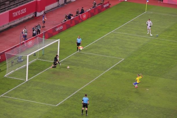 Reinier of Team Brazil scores a penalty kick during the penalty shoot out in the Men's Football Semi-final match between Mexico and Brazil on day...