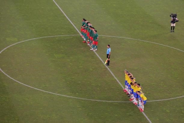 Both teams look on from the half way line in the penalty shoot out during the Men's Football Semi-final match between Mexico and Brazil on day eleven...
