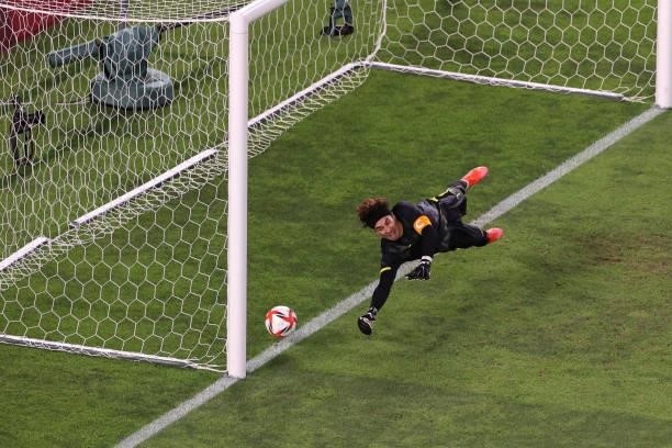 Guillermo Ochoa of Team Mexico dives to save the ball at the penalty shoot out during the Men's Football Semi-final match between Mexico and Brazil...