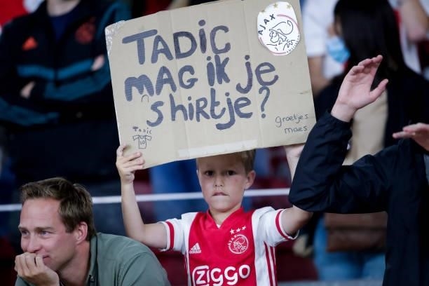 Young fan of Ajax with a banner during the Pre-season Friendly match between Ajax and Leeds United at the Johan Cruijff ArenA on August 4, 2021 in...