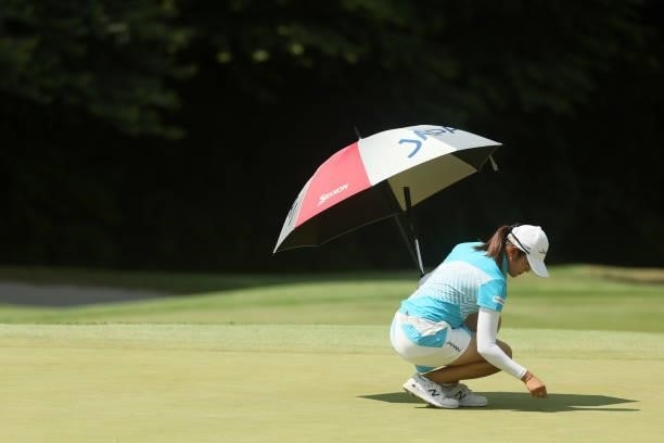 Mone Inami of Team Japan prepares to putt on the 17th green during the third round of the Women's Individual Stroke Play on day fourteen of the Tokyo...