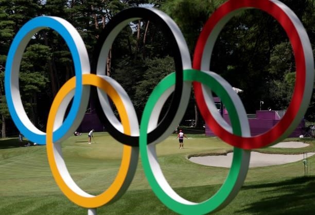 Nelly Korda of Team United States putts on the 16th green as seen through Olympic rings during the third round of the Women's Individual Stroke Play...