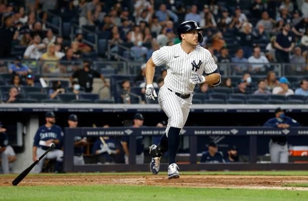 Giancarlo Stanton of the New York Yankees follows through on his seventh inning base hit against the Seattle Mariners at Yankee Stadium on August 05,...