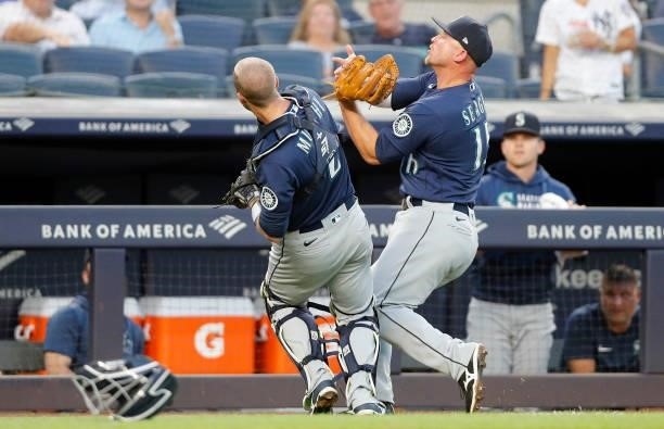 Kyle Seager of the Seattle Mariners makes a catch for an out in the second inning against the New York Yankees as he tries to avoid teammate Tom...