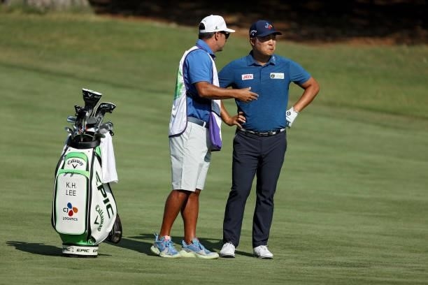 Lee of South Korea and his caddie line up a shot on the 10th green during the first round of the FedEx St. Jude Invitational at TPC Southwind on...