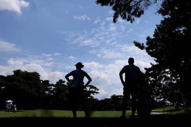 Nelly Korda of Team United States stands with caddie Jason McDede on the 15th fairway during the third round of the Women's Individual Stroke Play on...