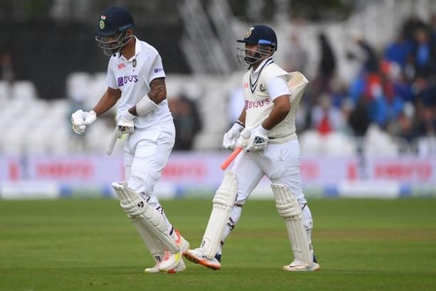 India batsmen KL Rahul and Rishabh Pant shelter their bats as they come off for rain during day three of the First Test Match between England and...
