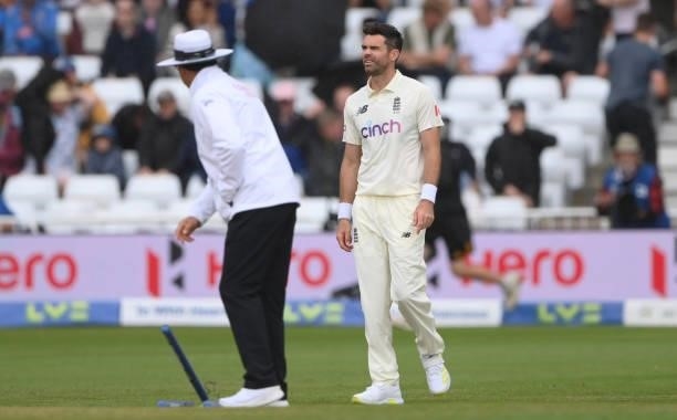 England bowler James Anderson looks on as the umpire pulls out the stumps as rain stops play during day three of the First Test Match between England...