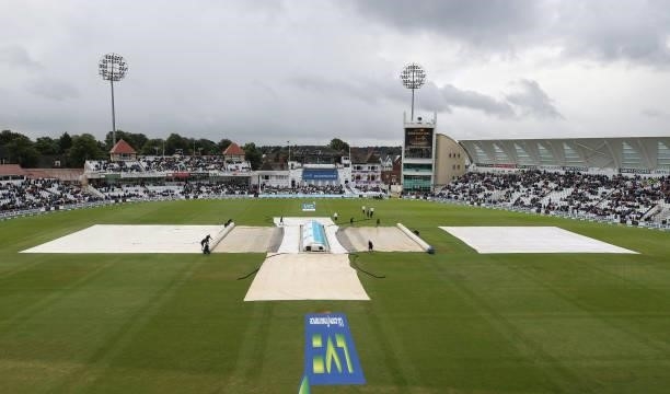 Covers are seen on the wicket as rain stops play during day three of the First LV= Insurance test match between England and India at Trent Bridge on...
