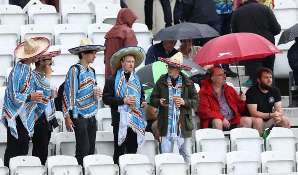 Spectators look on as rain stops play during day three of the First LV= Insurance test match between England and India at Trent Bridge on August 05,...