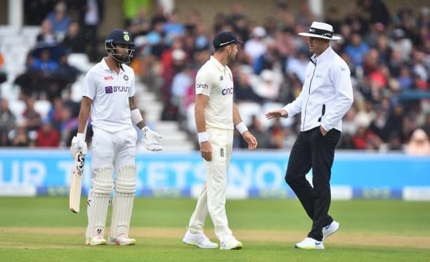 England bowler James Anderson has words with umpire Michael Gough as KL Rahul looks on as rain falls but play continues during day three of the First...