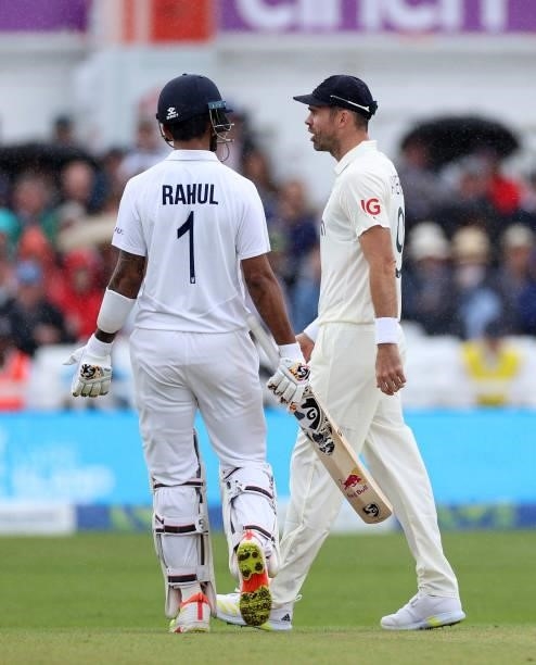 James Anderson of England talks to Rishabh Pant of India who was attempting to walk off due to a rain shower during day three of the First LV=...