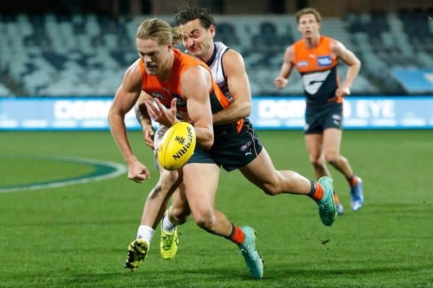 Luke Dahlhaus of the Cats tackles Harry Himmelberg of the Giants during the round 21 AFL match between Geelong Cats and Greater Western Sydney Giants...