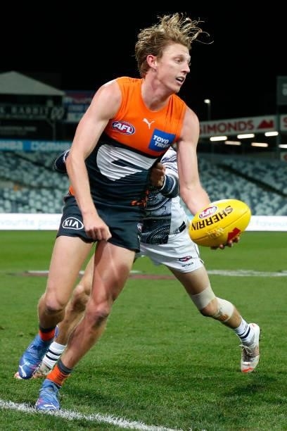 Lachie Whitfield of the Giants gathers the ball during the round 21 AFL match between Geelong Cats and Greater Western Sydney Giants at GMHBA Stadium...