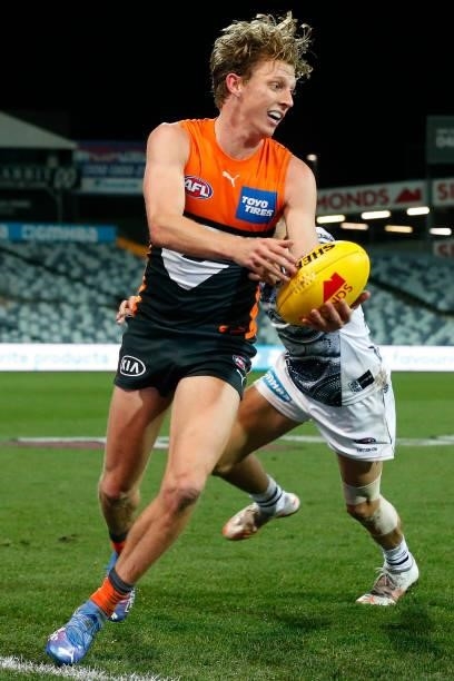 Lachie Whitfield of the Giants gathers the ball during the round 21 AFL match between Geelong Cats and Greater Western Sydney Giants at GMHBA Stadium...