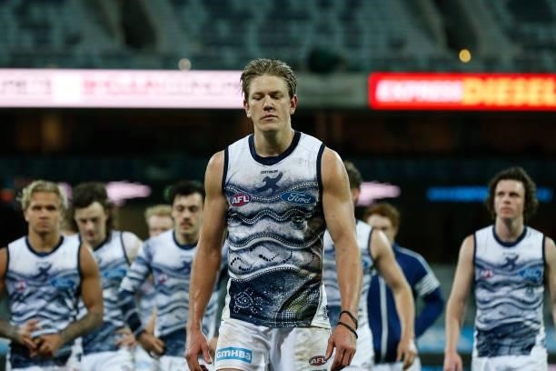 Dejected Geelong Cats players walk from the ground after the round 21 AFL match between Geelong Cats and Greater Western Sydney Giants at GMHBA...