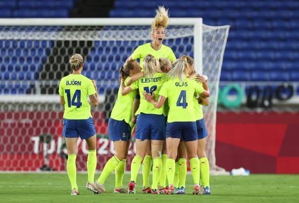 Sofia Jakobsson of Team Sweden jumps on top as Stina Blackstenius of Team Sweden celebrates with team mates after scoring their side's first goal...