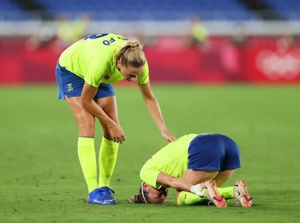 Kosovare Asllani of Team Sweden looks to be injured as she is checked on by team mate Fridolina Rolfo during the Women's Gold Medal Match between...