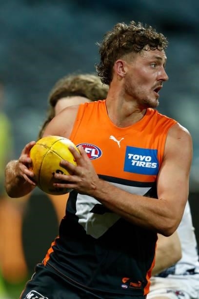 Harry Perryman of the Giants runs with the ball during the round 21 AFL match between Geelong Cats and Greater Western Sydney Giants at GMHBA Stadium...