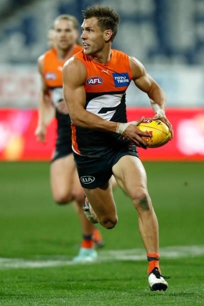 Matt De Boer of the Giants runs with the ball during the round 21 AFL match between Geelong Cats and Greater Western Sydney Giants at GMHBA Stadium...