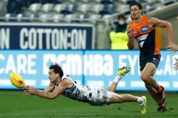 Luke Dahlhaus of the Cats handballs during the round 21 AFL match between Geelong Cats and Greater Western Sydney Giants at GMHBA Stadium on August...