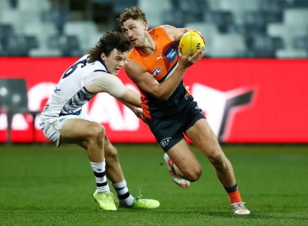 Harry Perryman of the Giants evades a tackle during the round 21 AFL match between Geelong Cats and Greater Western Sydney Giants at GMHBA Stadium on...