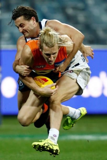 Luke Dahlhaus of the Cats tackles Nick Haynes of the Giants during the round 21 AFL match between Geelong Cats and Greater Western Sydney Giants at...