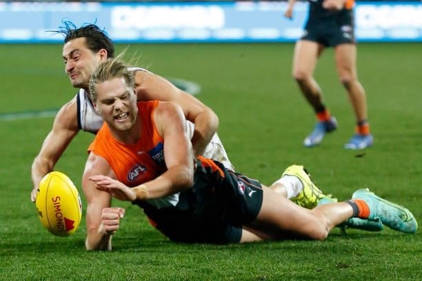Luke Dahlhaus of the Cats tackles Harry Himmelberg of the Giants during the round 21 AFL match between Geelong Cats and Greater Western Sydney Giants...