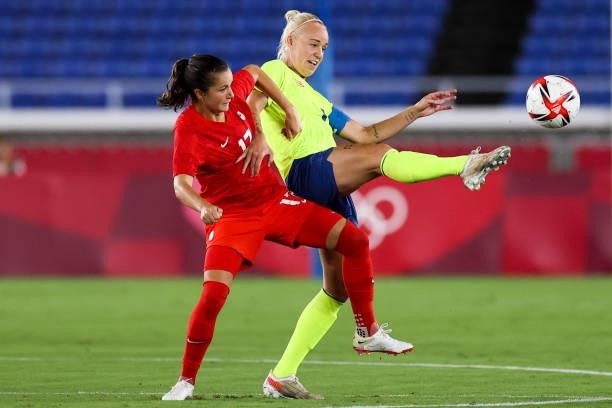 Caroline Seger of Sweden competes for the ball with Jessie Fleming of Canada during the Olympic women's football gold medal match between Sweden and...