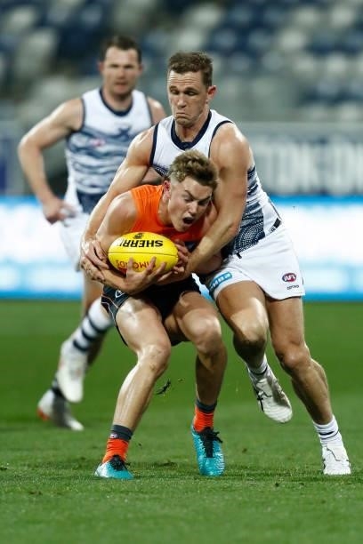 Joel Selwood of the Cats tackles Tanner Bruhn of the Giants during the round 21 AFL match between Geelong Cats and Greater Western Sydney Giants at...