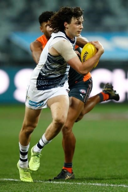 Jordan Clark of the Cats runs with the ball during the round 21 AFL match between Geelong Cats and Greater Western Sydney Giants at GMHBA Stadium on...