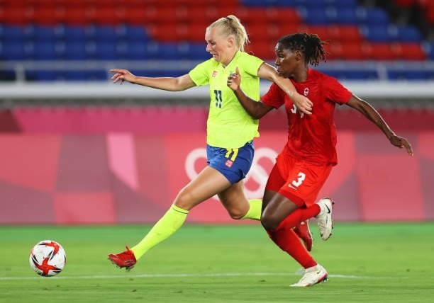 Stina Blackstenius of Team Sweden battles for possession with Kadeisha Buchanan of Team Canada during the Women's Gold Medal Match between Canada and...