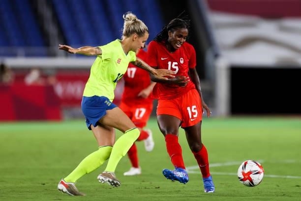 Nichelle Prince of Canada competes for the ball with Nathalie Bjorn of Sweden during the Olympic women's football gold medal match between Sweden and...